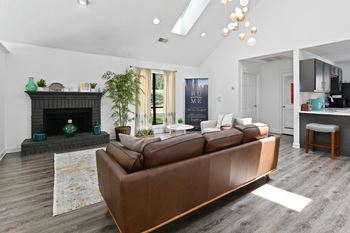 a living room with a leather couch and a fireplace